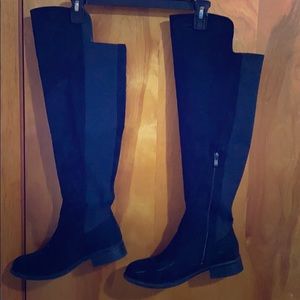 Over the knee black boots.